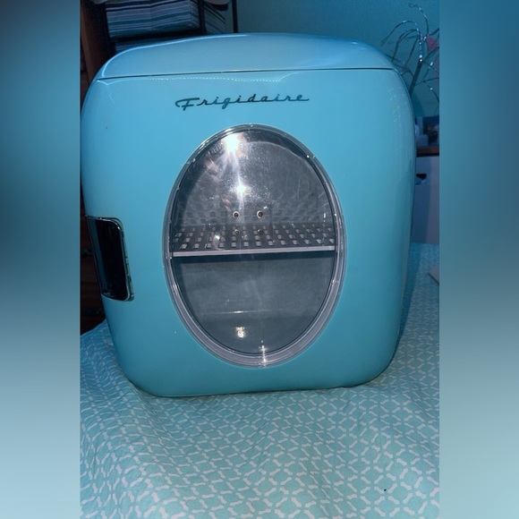 A teal mini fridge that will keep your drinks cold for a while! - Picture 2 of 4